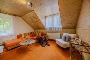 a living room with a couch and a table at Krásná pod Lysou horou in Krásná
