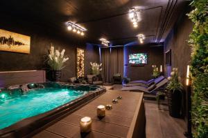 a hot tub in a living room with a tv at Luxury TABOO Villa & Spa in Medulin for 8 people with heated pool & wellness area in Medulin