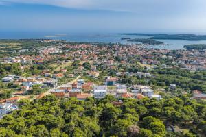 an aerial view of a city with houses and trees at Luxury TABOO Villa & Spa in Medulin for 8 people with heated pool & wellness area in Medulin
