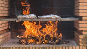 a brick oven with food being baked in foil at Casa Lia in Alcocer de Planes