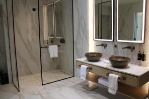 a bathroom with two sinks and a shower at Ollie's by the sea in Donja Lastva