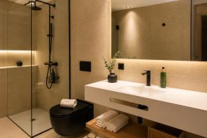 a bathroom with a sink and a shower at Mallorca Suites Playa De Palma in Palma de Mallorca +50 photos