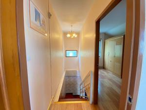 a hallway with a staircase in a house at Buriram Cozy Home in Buriram