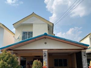 a house with a blue roof at Buriram Cozy Home in Buriram