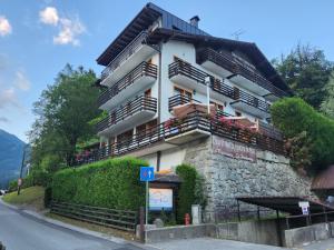 a building with balconies on the side of a street at Chalet Fiocco Di Neve in Pinzolo