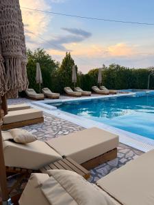 a pool with lounge chairs and a swimming pool at Riverside Apartments in Ulcinj +231 photos