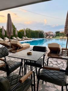 a view of a pool with tables and chairs at Riverside Apartments in Ulcinj