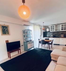a living room with a couch and a table at The Airport Loft in Otopeni
