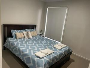 a bedroom with a bed with towels on it at stay live love in Epping