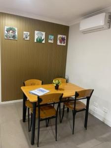 a dining room with a wooden table and chairs at stay live love in Epping