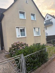 a house with white windows and a fence at Haus Milan in Holzminden