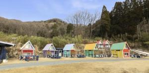 a row of colorful houses on the side of a road at パワースポットキャンプ場 in Shimoda