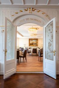 a door leading into a dining room with tables at Hotel des Balances in Lucerne