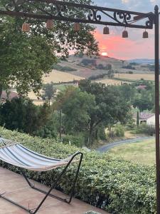 a hammock sitting on a porch overlooking a road at Chambre des Remparts in Lautrec