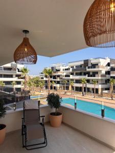 a balcony with two chairs and a swimming pool at Casa Lauri in Orihuela Costa