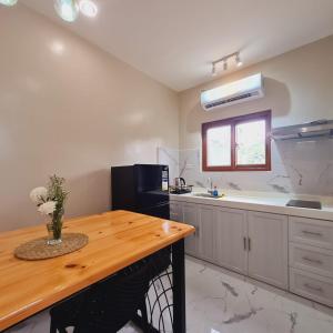 a kitchen with a wooden table and a sink at Strand  +2 photos