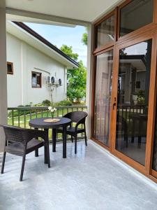 a patio with a table and chairs and a glass door at Strand 