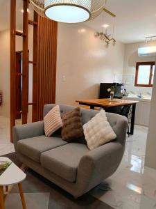 a living room with a couch with pillows on it at Strand 