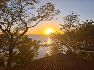 a sunset over the ocean from a house at Strand 
