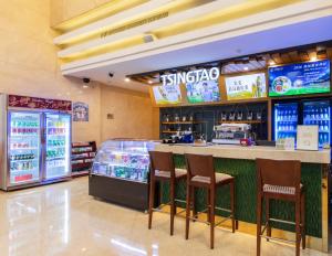 a fast food restaurant with a counter and stools at Shanghai Metropark Jichen Hotel in Shanghai