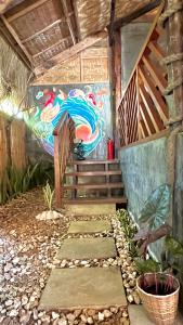 a painting on the side of a building with a pathway at Ginhawa Stay Mixed dorm 6 Bed in Burgos