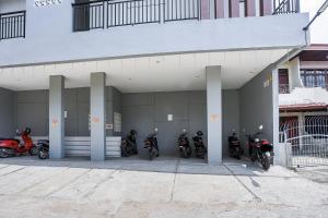 a group of motorcycles parked on the side of a building at Urbanview Hotel Aloevera Pontianak by RedDoorz in Pontianak +18 photos