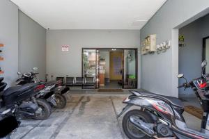 a row of motorcycles parked in a garage at Urbanview Hotel Aloevera Pontianak by RedDoorz in Pontianak