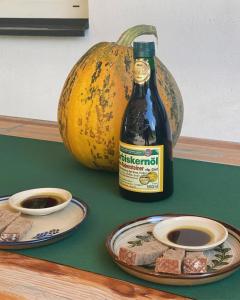 a bottle of beer next to a plate of food at Farmer-Rabensteiner in Bad Gams +13 photos