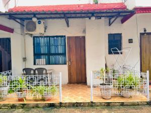 a house with potted plants in front of it at Elite Calangute Beach Holiday Apartments With Pool in Calangute