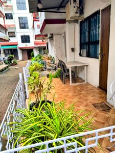 a balcony with a table and some plants at Elite Calangute Beach Holiday Apartments With Pool in Calangute