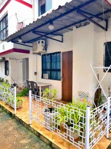 a balcony of a house with potted plants at Elite Calangute Beach Holiday Apartments With Pool in Calangute +31 photos