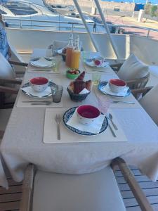 a table with plates of food on a boat at Yacht Laetitia Delta in Fréjus