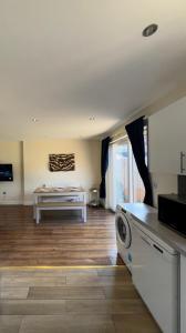 a living room with a bed and a table at Enyo House Brentford London in Brentford