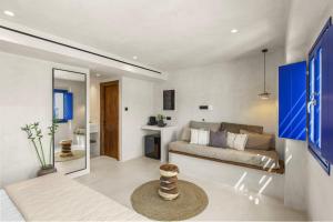 a living room with a couch and a bedroom at Alexandros Apartments in Naousa