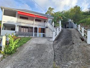 a house with a driveway in front of it at Terrasson GOLD2 in Les Abymes