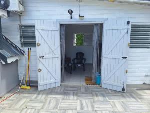 an open garage door with a chair in it at Terrasson GOLD2 in Les Abymes
