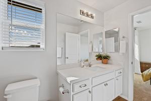 a white bathroom with a sink and a mirror at Grand Canyon Getaway Near Snowbowl Flagstaff Sedona Family-Friendly Sleeps 14 in Bellemont +48 photos