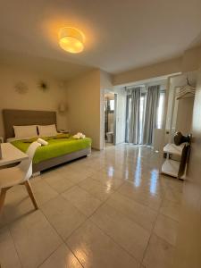 a bedroom with a green bed and a tiled floor at Kiperi Exclusive in Parga