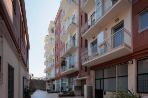 an alley in an apartment building at VItruVIo POP in Fano