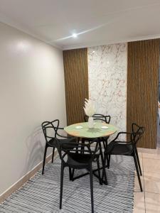 a dining room with a table and chairs on a rug at Cambridge Boutique Stay in Chiselhurst