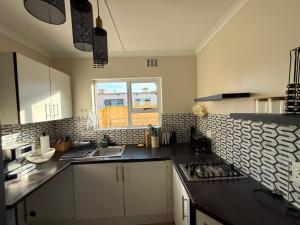 a kitchen with a sink and a counter top at Cambridge Boutique Stay in Chiselhurst