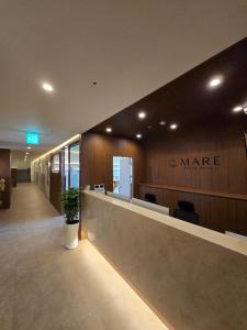 an office lobby with a waiting area with a potted plant at Mare Suite Hotel in Incheon