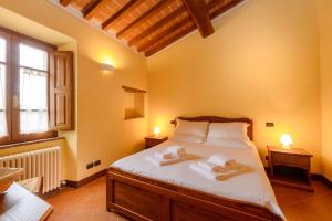 a bedroom with a bed with two towels on it at Tenuta Santavenere in San Bartolomeo