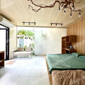 a bedroom with a bed and a couch at Mai Home in Ấp An Mỹ