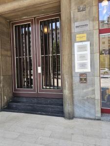 a door of a building with wrought iron gates at 7 CENTRALE Rooms & Suite in Milan