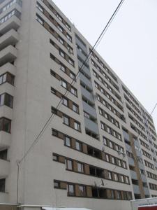 a large apartment building with windows on the side of it at Cluj Accommodation Nasaud in Cluj-Napoca