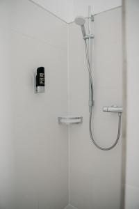 a shower with a shower head in a bathroom at Angermühle Landgasthof in Altenmarkt an der Alz +41 photos
