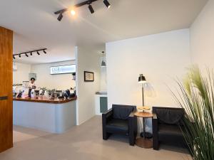 a waiting room with two chairs and a counter at Pattaya City Center Residence by K2 in Pattaya