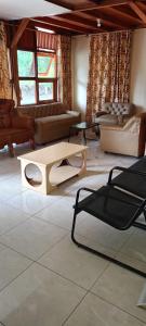 a living room with couches and tables in it at Homestay Zanoleos in Tomohon