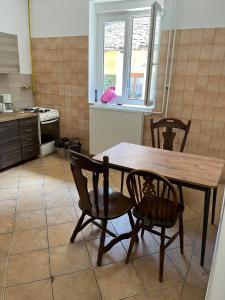 a kitchen with a wooden table and two chairs at Jackys hostel 9 in Sremski Karlovci